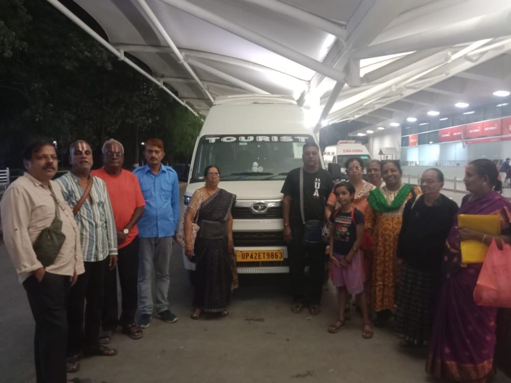 Happy yatra group next to their private tourist van.