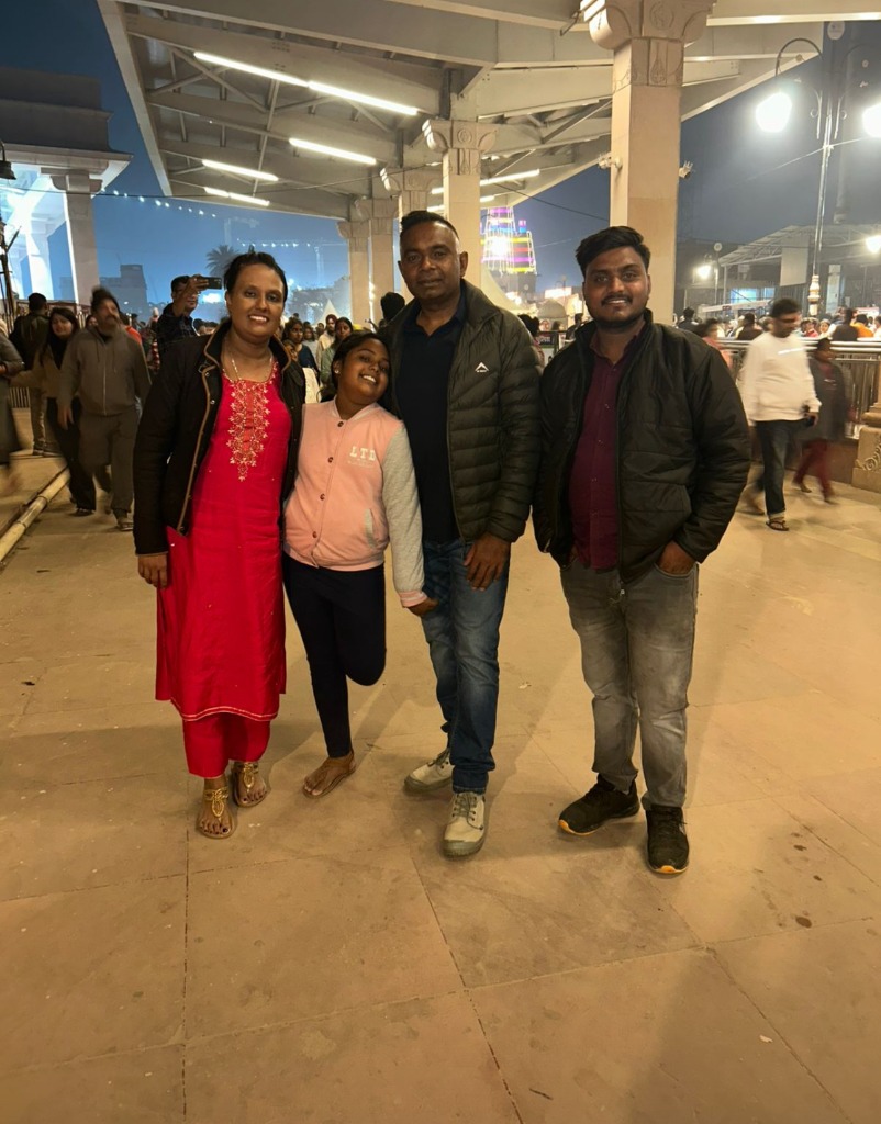 Devotees group posing next to the holy Ganga river at Varanasi.