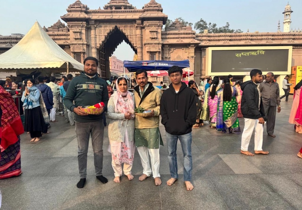 A family group posing in front of the main temple entrance gate.